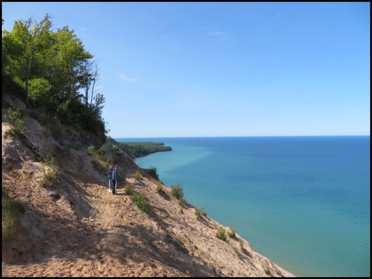 people admiring Superior Lake and the dunes along the shore