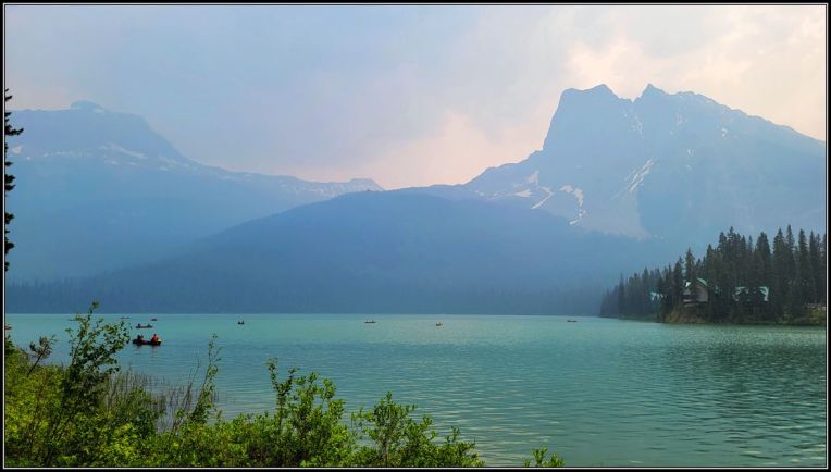 Emerald lake under smoky skies